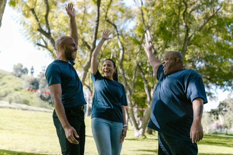 a group of people standing on top of a lush green field, overweight, laughingstock, at a park, profile image