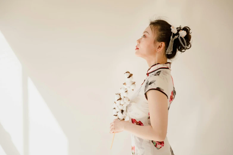 a woman in a white dress holding a bouquet of flowers, inspired by Dai Xi, pexels contest winner, visual art, with black pigtails, cheongsam, in white room, profile image