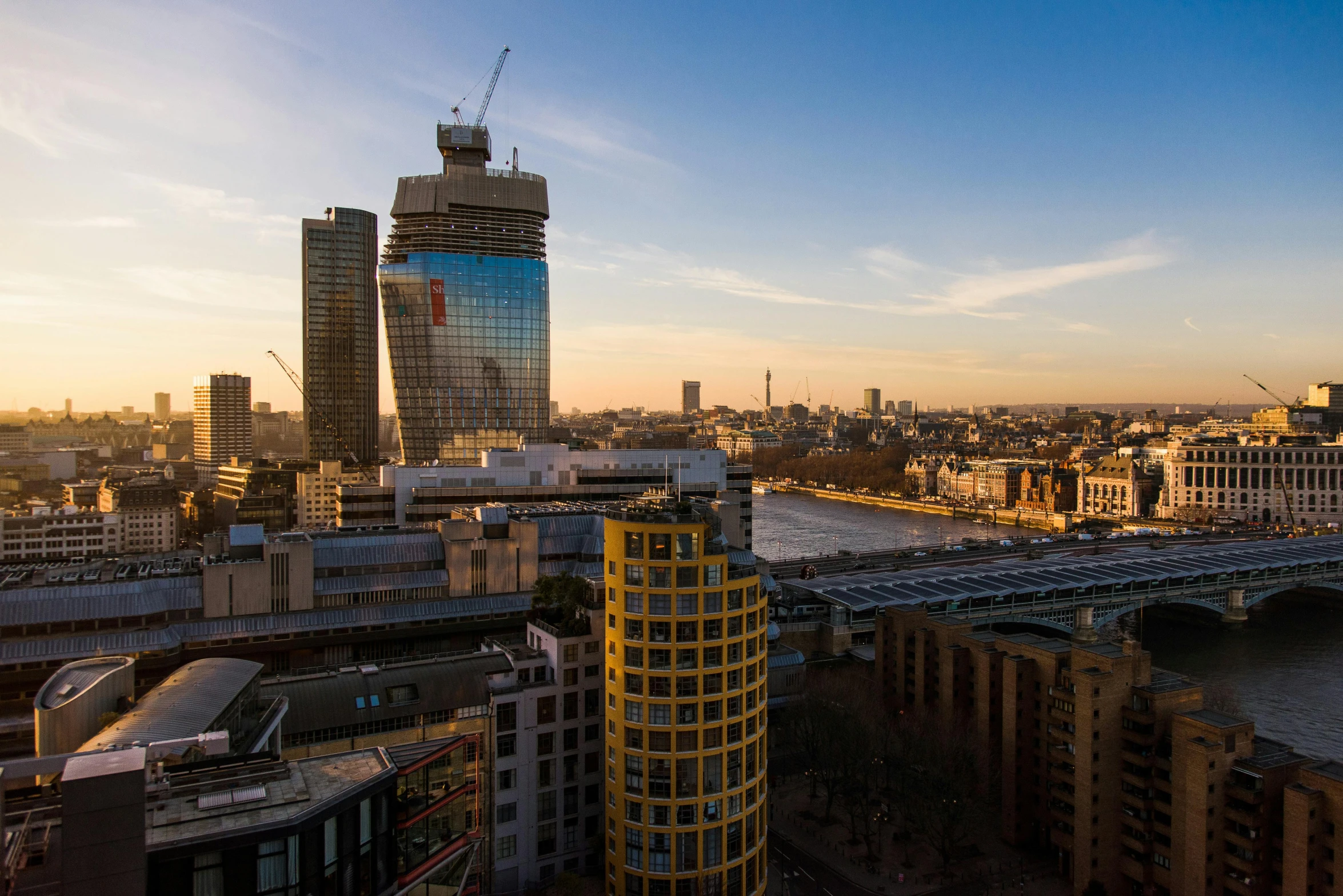 a view of a city from the top of a building, by Joseph Severn, pexels contest winner, modernism, london south bank, golden hour 4k, construction, slide show