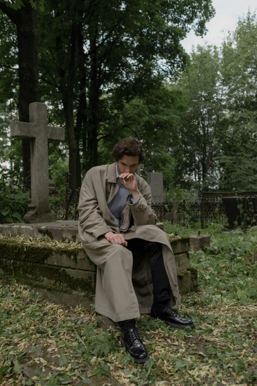 a woman sitting on a bench in a cemetery, an album cover, pexels, renaissance, he is wearing a trenchcoat, dean winchester, devastated, daniil kudriavtsev