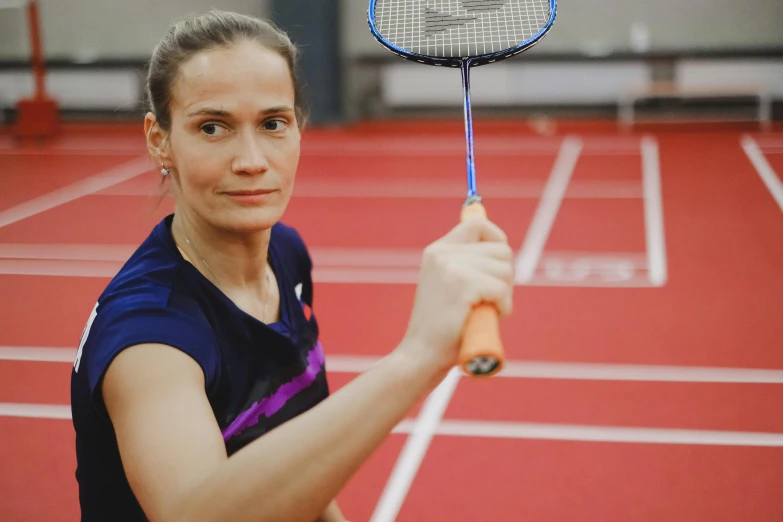 a woman holding a tennis racquet on a tennis court, a portrait, by Matija Jama, pexels contest winner, half-woman half-butterfly, indoor, she is holding a long staff, 15081959 21121991 01012000 4k