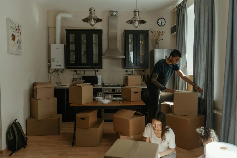 a man and a woman moving boxes in a living room, by Lee Loughridge, pexels contest winner, hurufiyya, zeen chin and farel dalrymple, in a kitchen, profile image, small houses