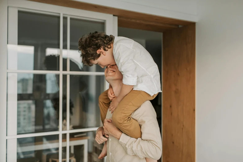 a man holding a little boy on his shoulders, by Emma Andijewska, pexels contest winner, renaissance, at home, lachlan bailey, loosely cropped, covered in