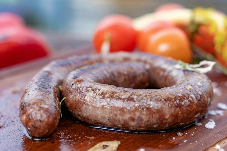 a couple of sausages sitting on top of a wooden cutting board, inspired by Géza Dósa, rondel, profile image, molten, exterior shot