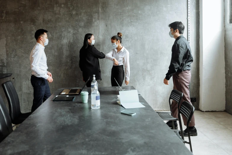 a group of people standing around a long table, pexels contest winner, shaking hands, office clothes, covid, background image