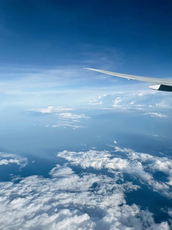 the wing of an airplane flying above the clouds, pexels contest winner, hurufiyya, thumbnail, clouds and wings and waves, overview, slide show