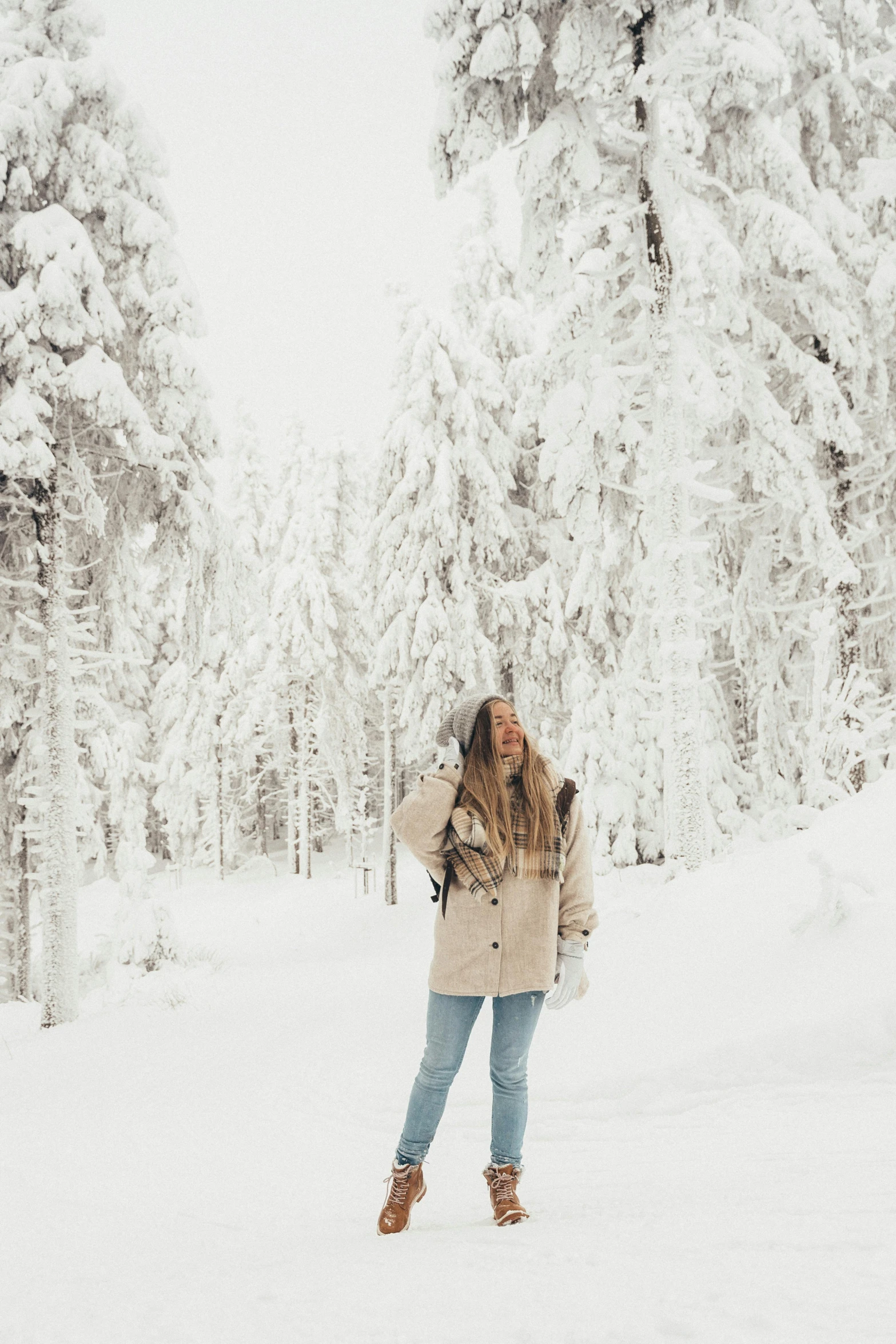 a woman standing in the middle of a snowy forest, a picture, trending on vsco, in the swiss alps, 🎀 🍓 🧚, an all white human