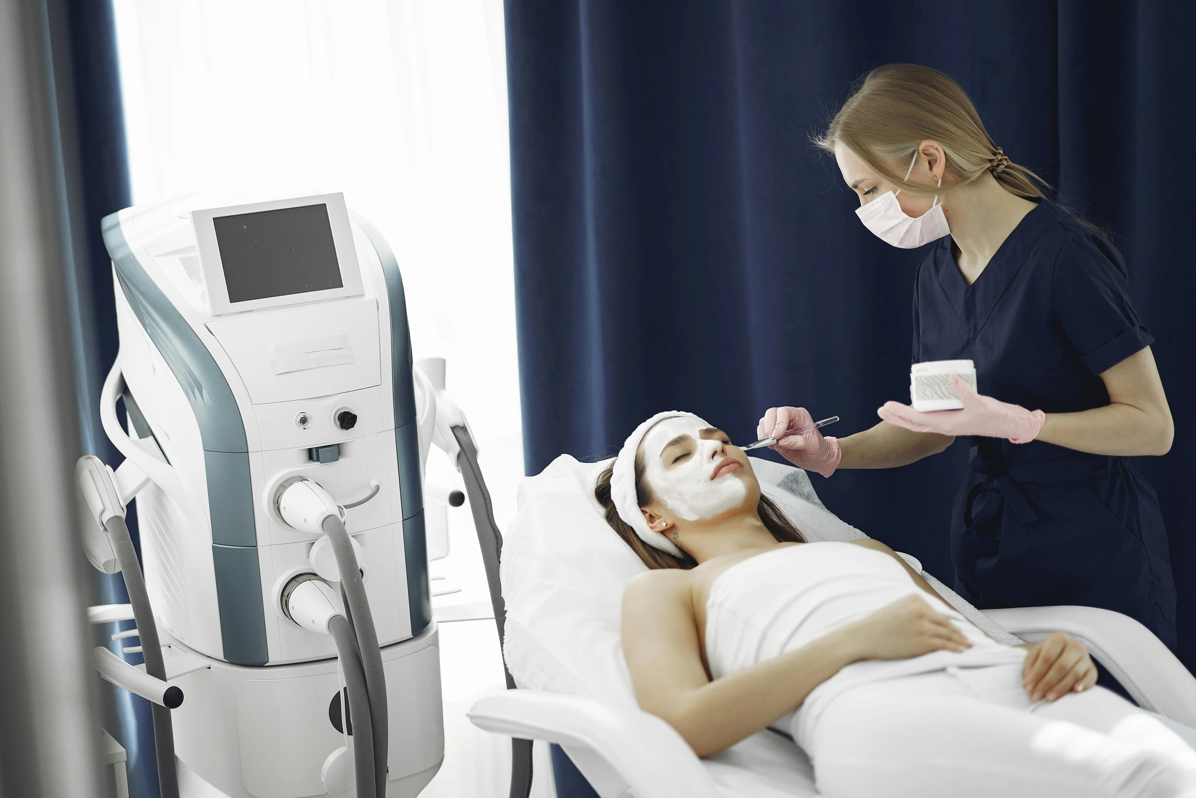 a woman laying in a hospital bed with a mask on, by Évariste Vital Luminais, shutterstock, massurrealism, pronounced facial contouring, with electric arc device, in professional makeup, korean