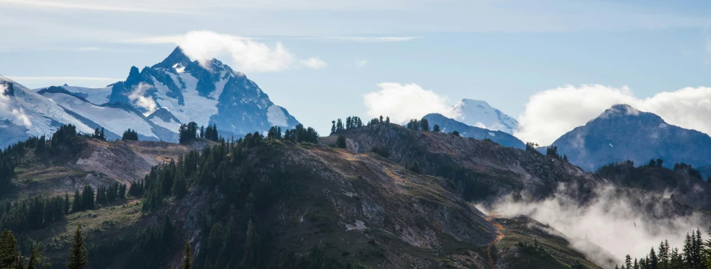 a group of people standing on top of a mountain, by Jessie Algie, unsplash contest winner, process art, cascadia, seen from a distance, pristine and clean, promo image