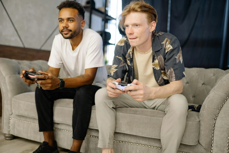 two men sitting on a couch playing a video game, pexels, casual pose, épaule devant pose, ad image, brunette boy and redhead boy