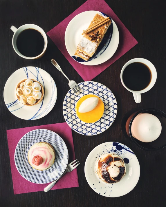 a table topped with plates of food and cups of coffee, eating cakes, instagram picture, curated collections, plating