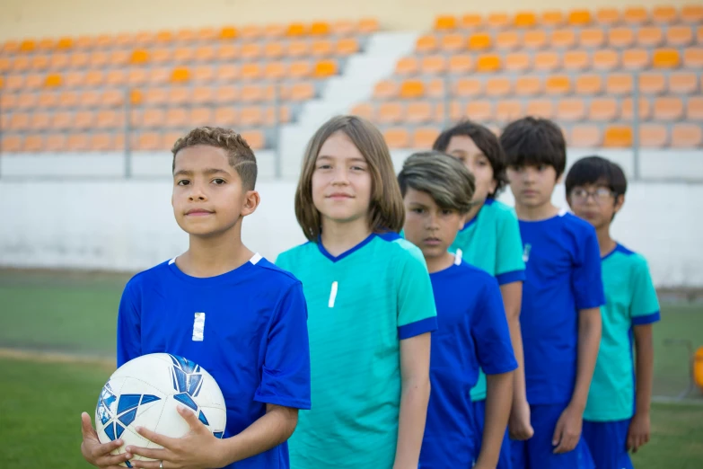 a group of children standing next to each other holding a soccer ball, a picture, shutterstock, antipodeans, oman, waiting to strike, 15081959 21121991 01012000 4k, actors