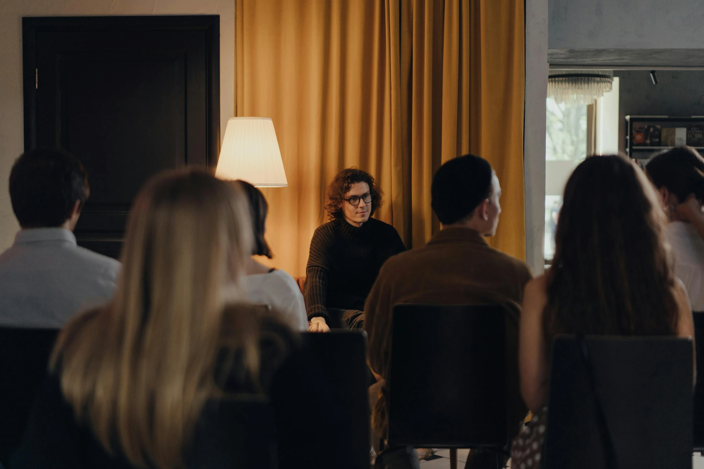 a group of people sitting around a table in a room, by Jesper Knudsen, unsplash, visual art, emma watson with anxious, hotel room, standing in class, ignant