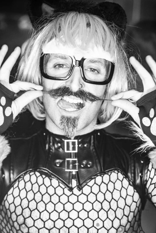 a black and white photo of a man in a cat suit, an album cover, inspired by Bernd Fasching, reddit, small blond goatee, jessica nigri, ricky berwick, barry chuckle