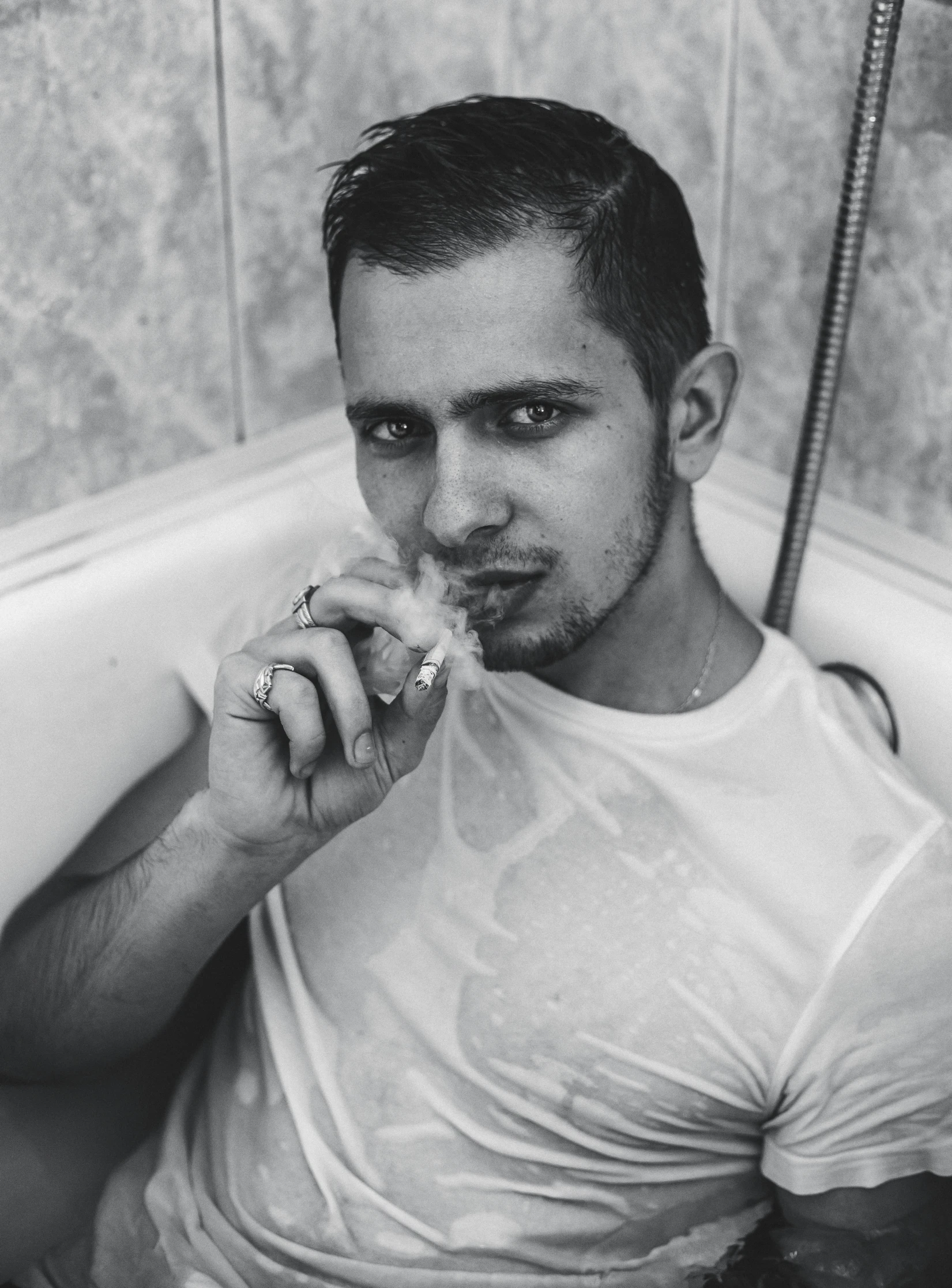 a man sitting in a bathtub brushing his teeth, a black and white photo, inspired by Niklaus Manuel, hayden christensen, wet t shirt, smoking a cigarrette🚬, cristi balanescu
