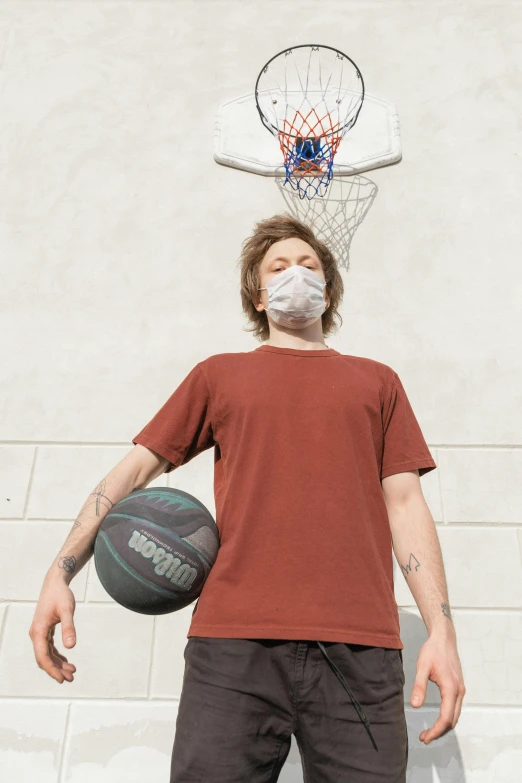 a man standing in front of a basketball hoop, one single mask, neckbeard, wearing a t-shirt, brown