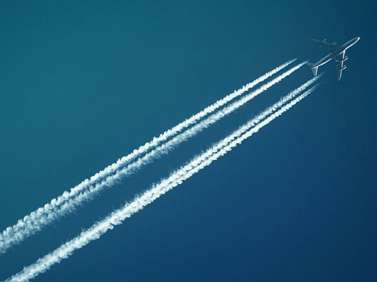 a couple of airplanes flying through a blue sky, pexels contest winner, plasticien, energy trails, profile image, on the runway, 3 layers of sky above each other