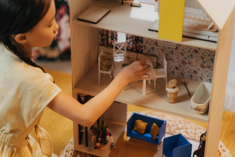 a little girl is playing with a doll house, pexels contest winner, arts and crafts movement, avatar image, miniaturecore, ikea, 3 d print