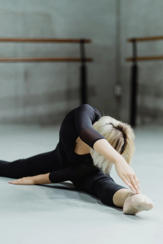 a woman in a black leo leo leo leo leo leo leo leo leo leo leo leo leo, inspired by Elizabeth Polunin, pexels contest winner, arabesque, doing splits and stretching, a blond, featured, square