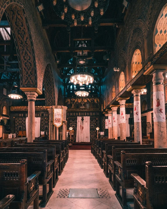 the inside of a church with pews and a chandelier, by Julia Pishtar, trending on unsplash, romanesque, cairo, non-binary, 🚿🗝📝