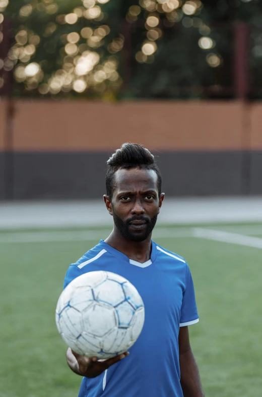 a man holding a soccer ball on a soccer field, dark skinned, man with beard, 15081959 21121991 01012000 4k, (38 years old)