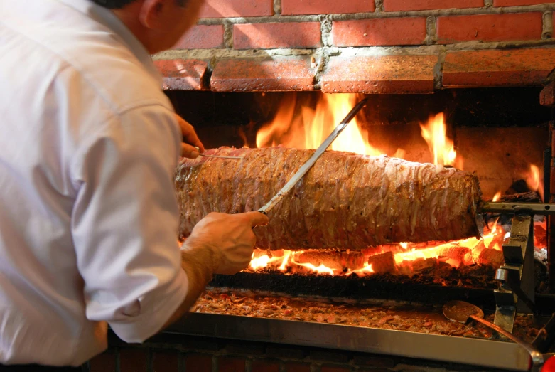 a man that is standing in front of a fire, food, carving, massive wide trunk, profile image