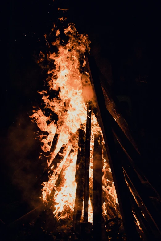 a bonfire is lit up in the dark, renaissance, smouldering charred timber, spire, festivals, rectangle