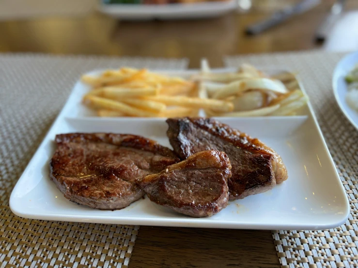 a white plate topped with steak and french fries, gui guimaraes, thumbnail, são paulo, full picture