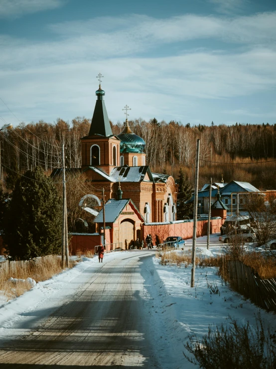 a church sitting on the side of a snow covered road, inspired by Andrei Rublev, pexels contest winner, russian village, 🚿🗝📝, ground level view of soviet town, near forest