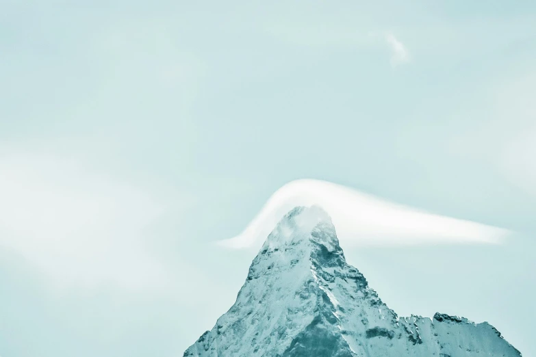 a mountain covered in snow under a cloudy sky, an album cover, trending on unsplash, postminimalism, light blue clear sky, spire, swiss modernizm, profile picture 1024px