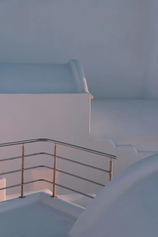 a man riding a snowboard on top of a snow covered slope, an abstract sculpture, inspired by Ricardo Bofill, unsplash, modernism, look down a cellar staircase, on a super yacht, early morning light, santorini