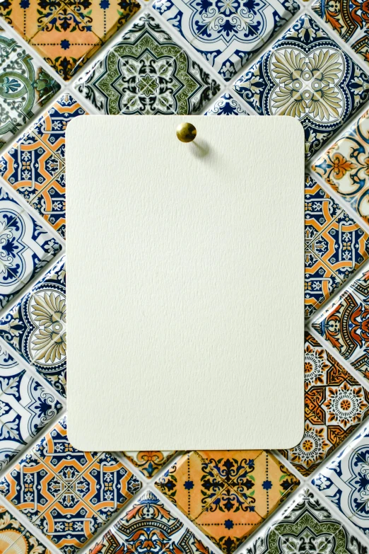 a piece of paper pinned to a tile wall, unsplash, arabesque, card back template, spanish, thumbnail, archival quality image