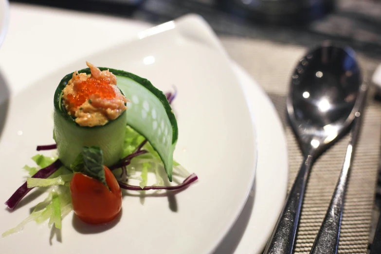 a close up of a plate of food on a table, cucumber, offering a plate of food