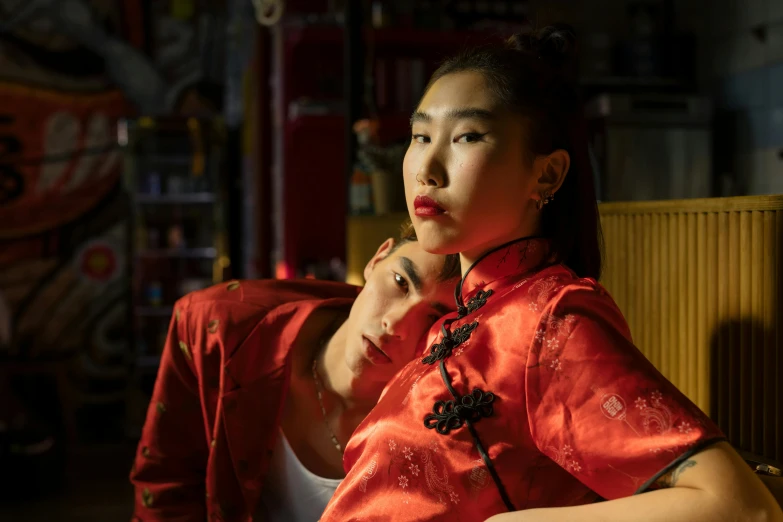 a woman in a red dress poses for a picture, a portrait, inspired by Wang Duo, 8 0 s asian neon movie still, lesbians, robes with golden characters, jordan grimmer and natasha tan