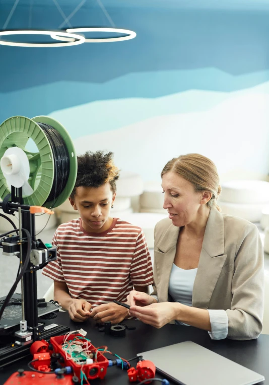 a woman and a child looking at a 3d printer, a digital rendering, pexels contest winner, renaissance, incubator medpods, avatar image, american school, mid shot portrait