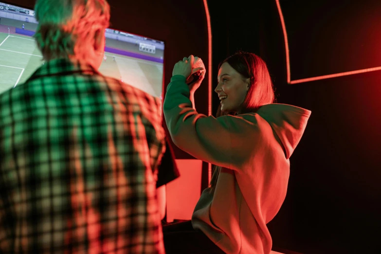 a man and a woman playing a video game, pexels contest winner, interactive art, portrait of billie eilish, giant red led screens, teenage engineering moad, showstudio