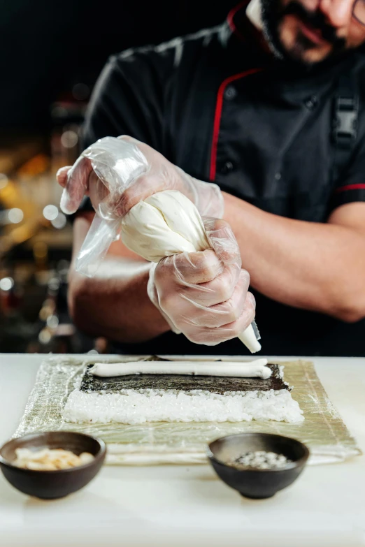 a man in a black shirt is preparing food, a marble sculpture, inspired by Cheng Zhengkui, trending on pexels, art nouveau, white apron, conch shell, dry ice, plastic wrap