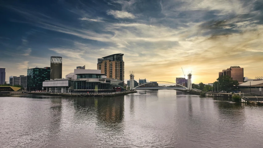 a body of water with a bridge and buildings in the background, inspired by Edwin Deakin, pexels contest winner, modernism, manchester, panoramic, fan favorite, central hub