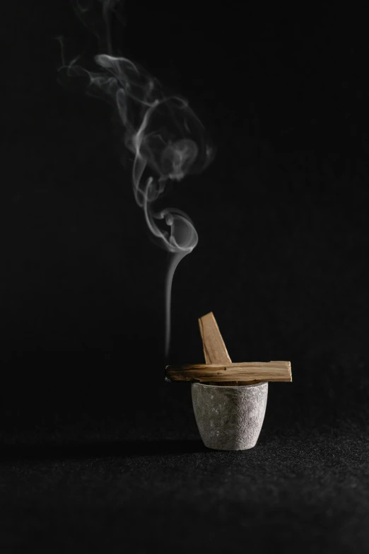 a cigarette with smoke coming out of it, by Matthias Stom, unsplash, conceptual art, alchemical still made from clay, david kassan, john pawson, pot