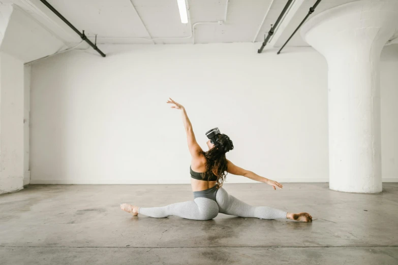 a woman doing a yoga pose in a white room, unsplash, arabesque, background image, female dancer, half-body shot, photographed in film