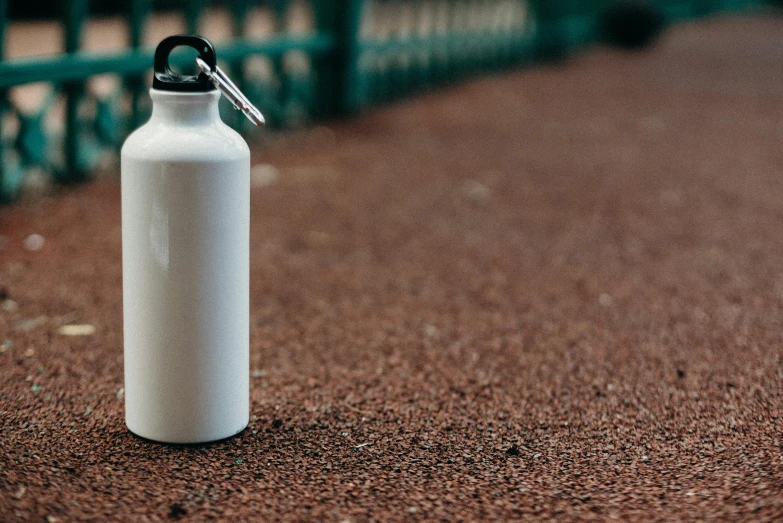 a white water bottle sitting on the ground, pexels contest winner, no - text no - logo, white steel, small, thumbnail