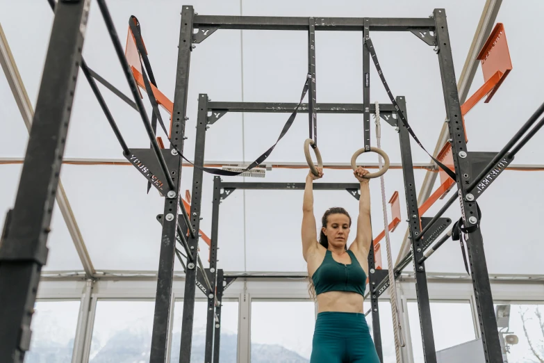 a woman doing pull ups in a crossfit gym, pexels contest winner, arabesque, avatar image, nature outside, whistler, lachlan bailey