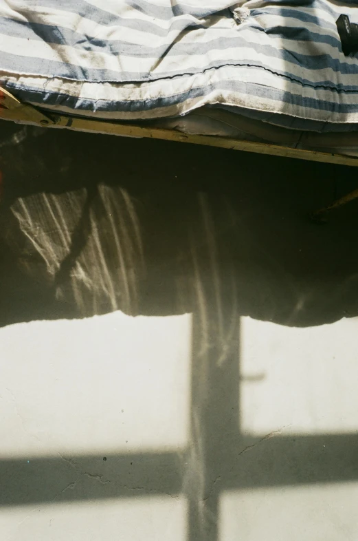 a man laying on top of a bed next to a window, a picture, by Attila Meszlenyi, flowing cloth and smoke, sun and shadow, slide show, nepal