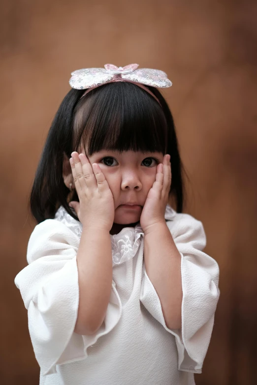 a little girl covering her face with her hands, an album cover, inspired by Nara Yoshitomo, pexels contest winner, hyperrealism, bowknot, disappointed, young cute wan asian face, portrait of princess