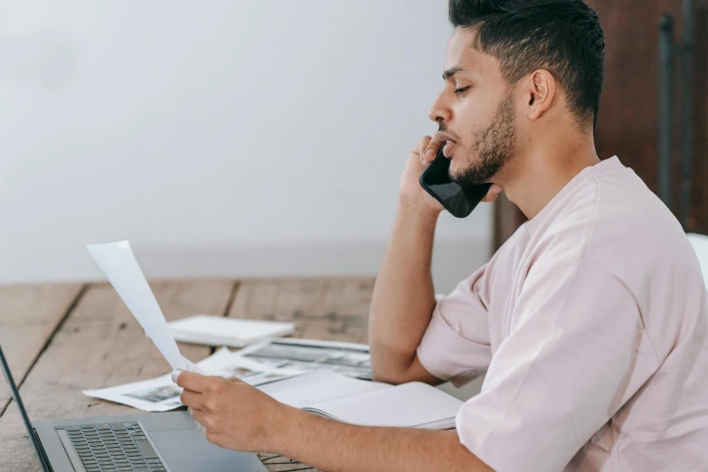 a man sitting in front of a laptop talking on the phone, trending on pexels, figuration libre, high quality paper, profile image, 1 2 9 7, maintenance