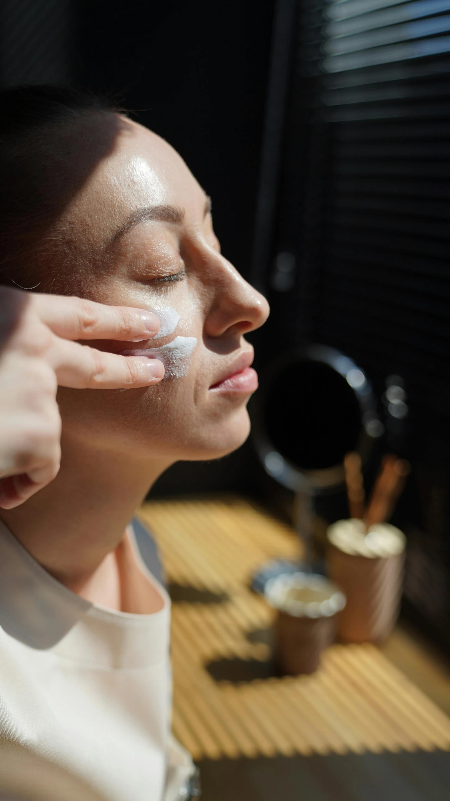 a woman is putting cream on her face, by Jessie Algie, pexels, renaissance, manuka, profile image, behind the scenes photo, thumbnail