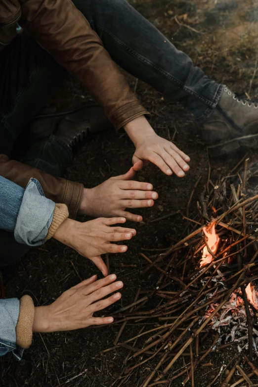 a group of people sitting around a campfire, trending on pexels, land art, realistic hands, soft texture, ignant, a wooden