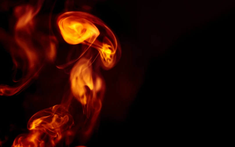 a close up of a fire on a black background, a picture, by Daniel Lieske, pexels, digital art, orange yellow ethereal, atmospheric red effects, tiny firespitter, volumetric smoke and shadows