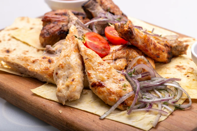 a wooden cutting board topped with lots of food, by Micha Klein, grilled chicken, greek ameera al taweel, thumbnail, restaurant menu photo