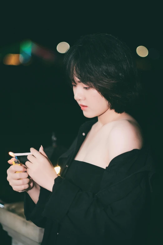 a woman looking at her cell phone in the dark, a picture, by Yang J, trending on pexels, realism, black haired yoongi, with an ashtray on top, thoughtful pose, with a bob cut